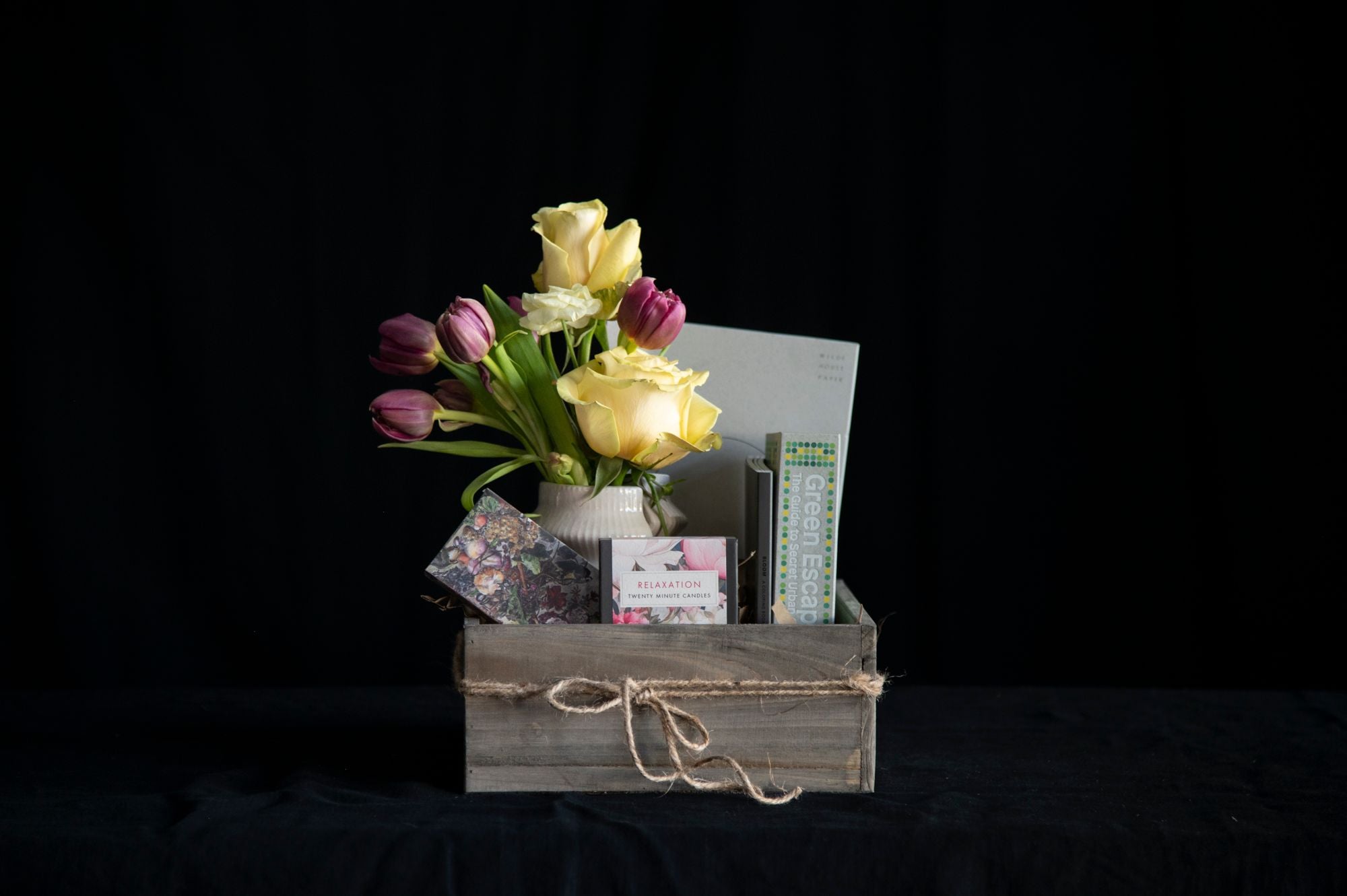 Gift set that includes flowers, bookend, book, meditation candles, and matches