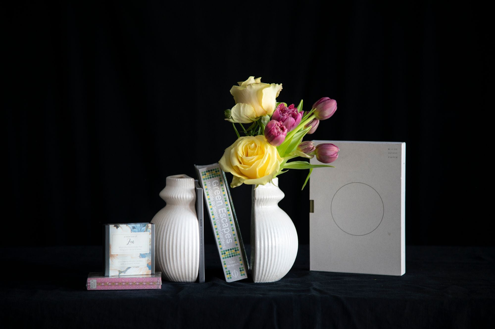 Gift set that includes flowers, bookend, book, meditation candles, and matches