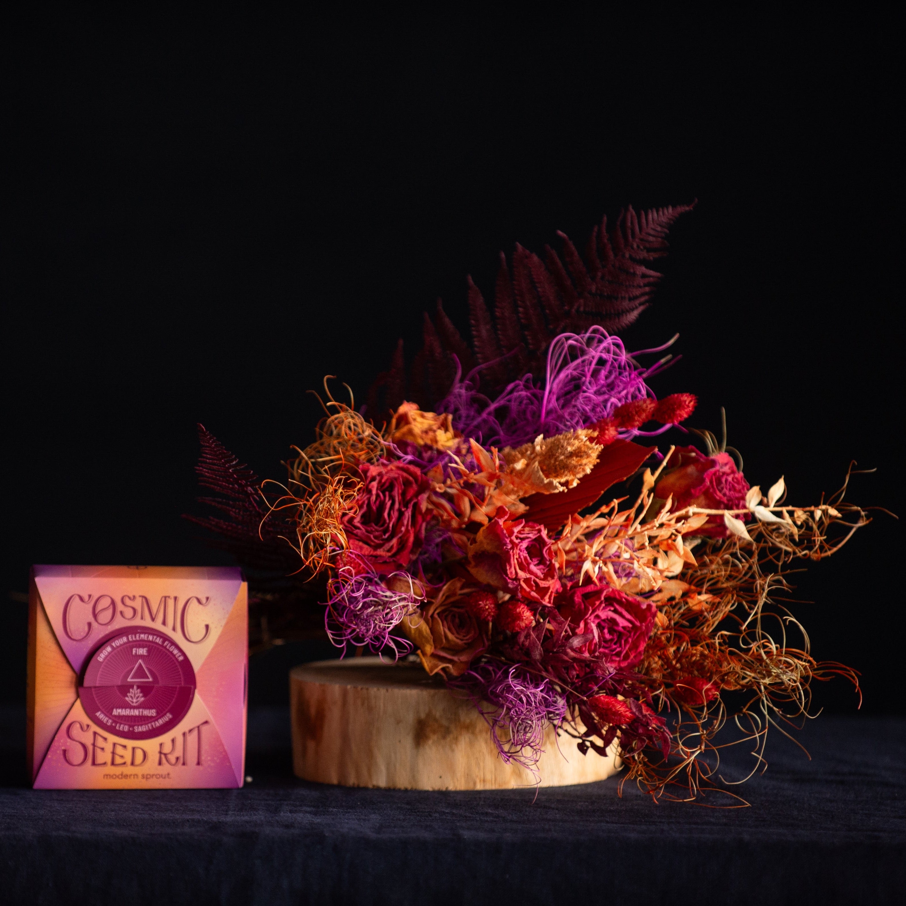 A bouquet of preserved & dried flowers in FIRE colors with a coordinating cosmic seed kit.