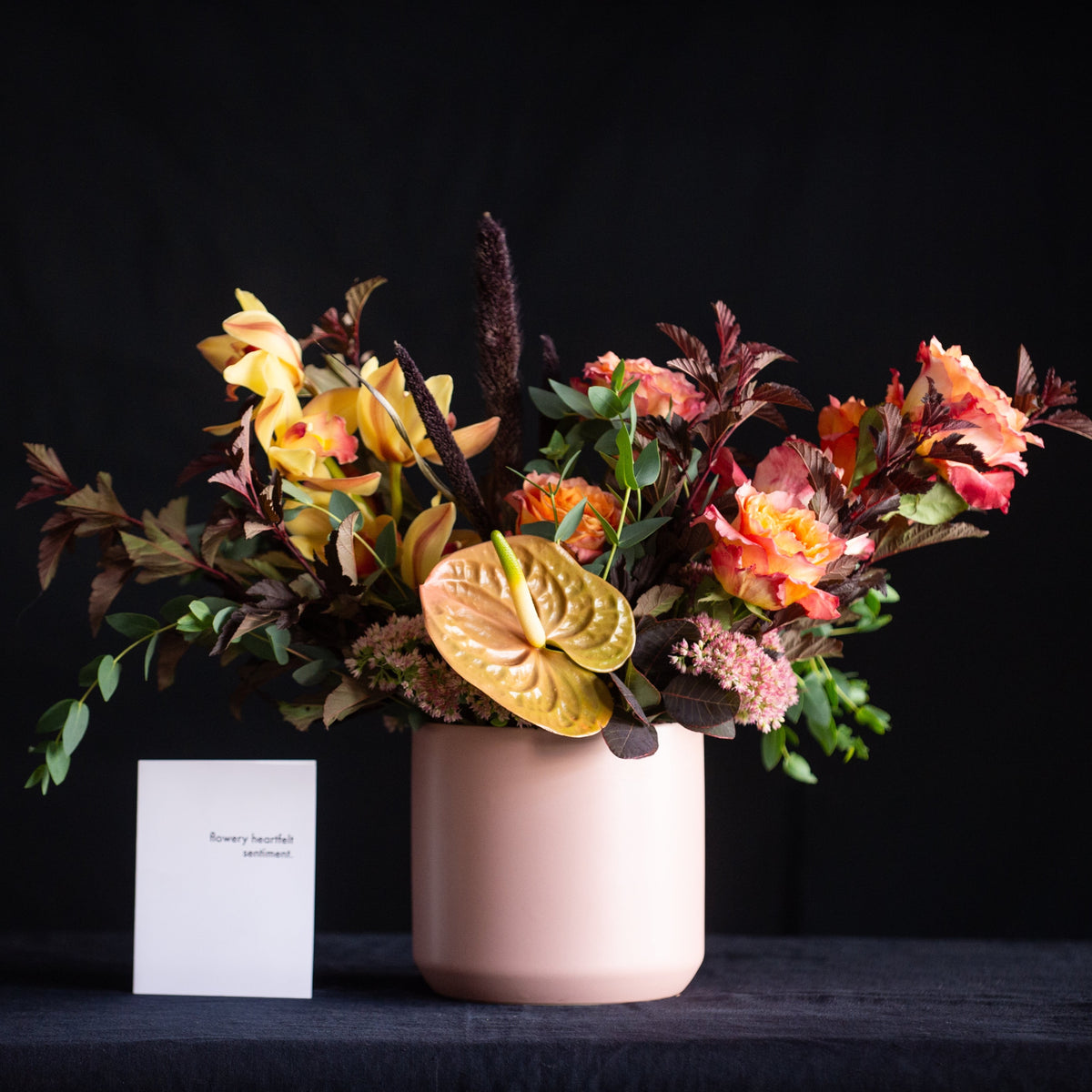 This harvest of a floral design has it all - roses, orchids, anthurium, fall leaves, in a color palette that is to die for!