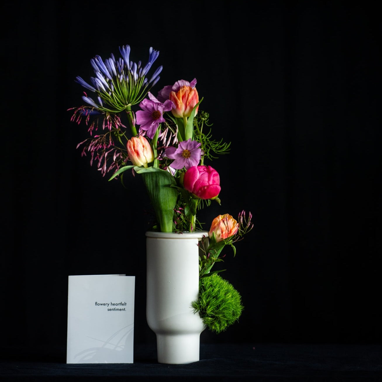 Mother's Day flowers in a modern architectural vase with a flower frog