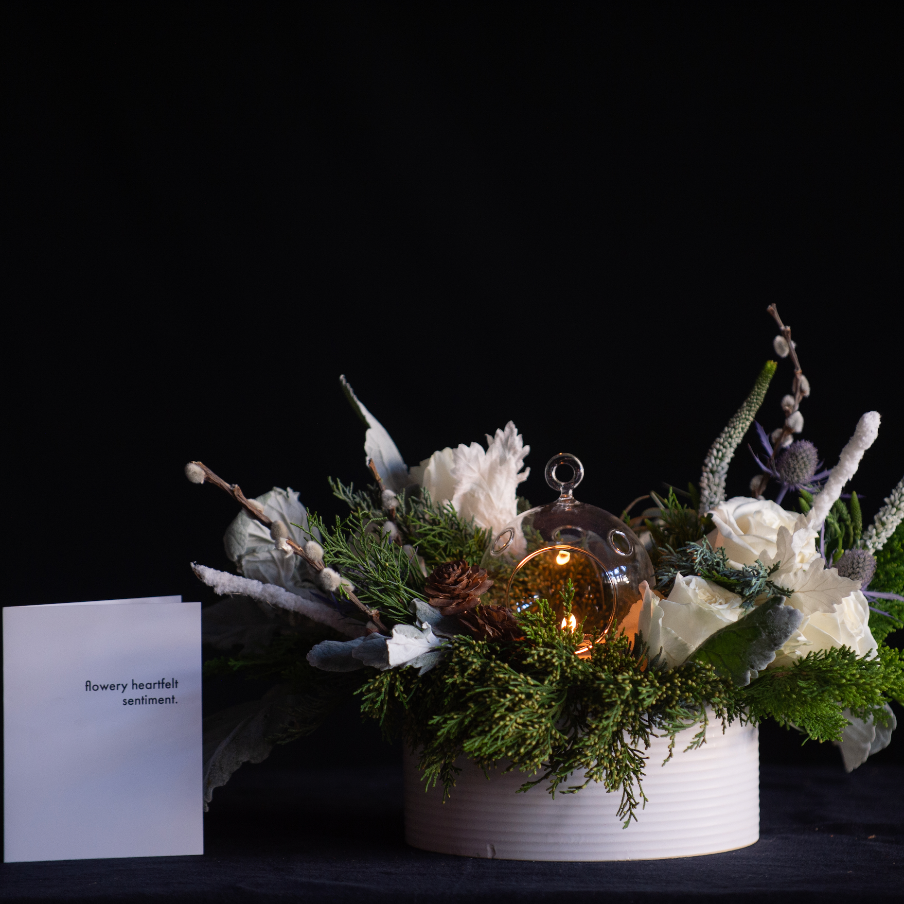 White winter holiday centerpiece with candlelight