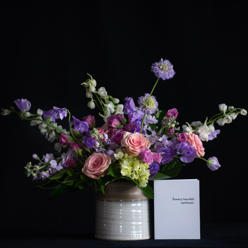 Luxury Spring Floral design of novelty pink and lavender stems in a ceramic vessel. Made by a local florist.