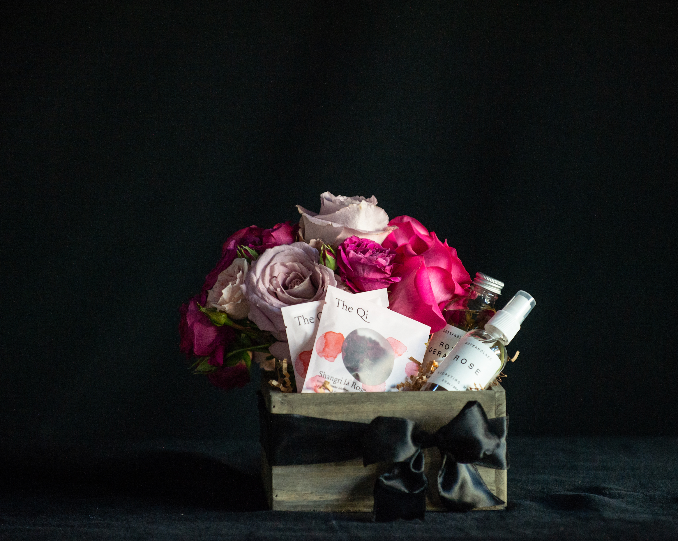 Gift box filled with all things roses - a rose bouquet, rose tea, rose facial steam, and rose mist.