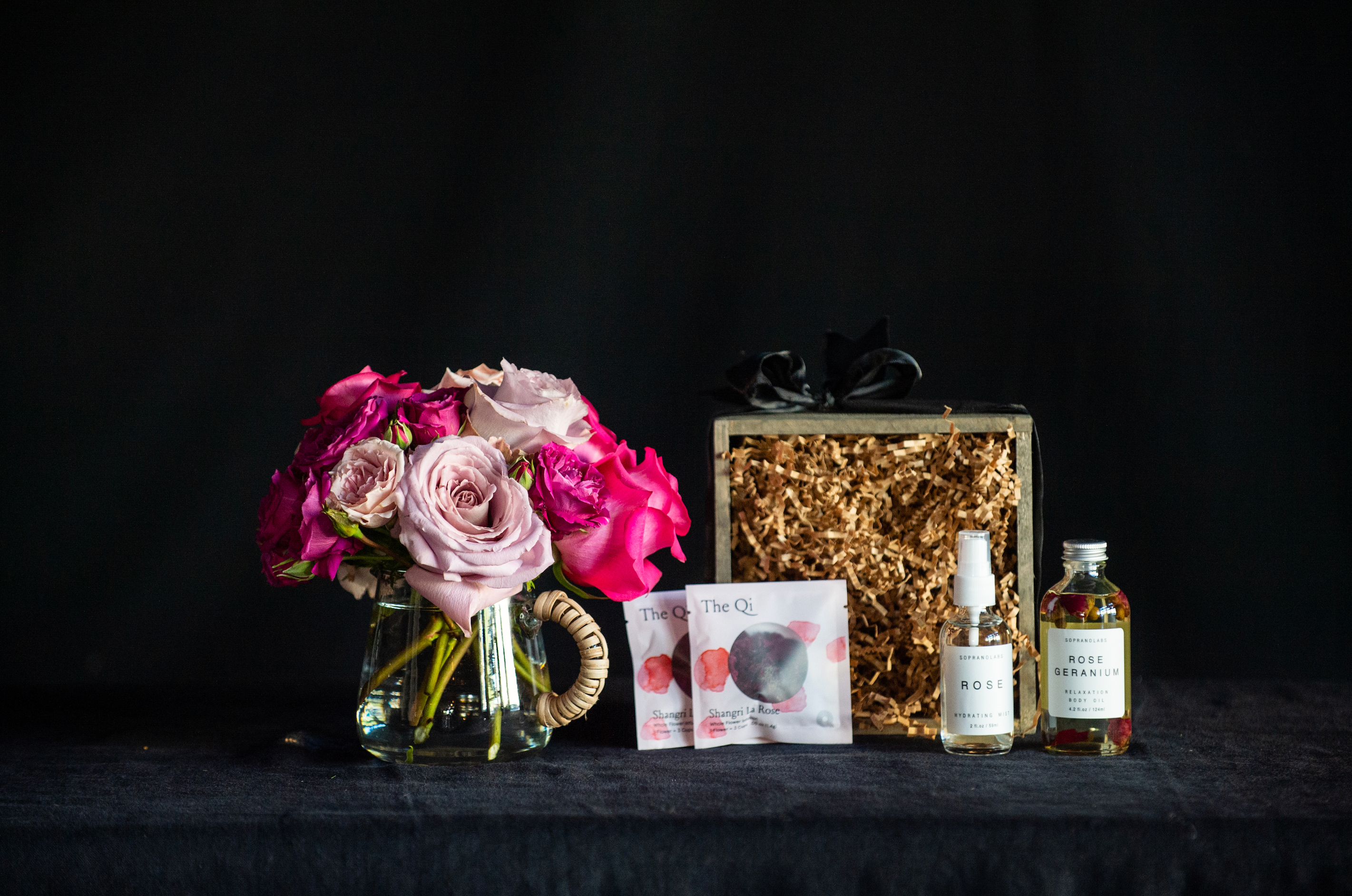 Gift box filled with all things roses - a rose bouquet, rose tea, rose facial steam, and rose mist. 