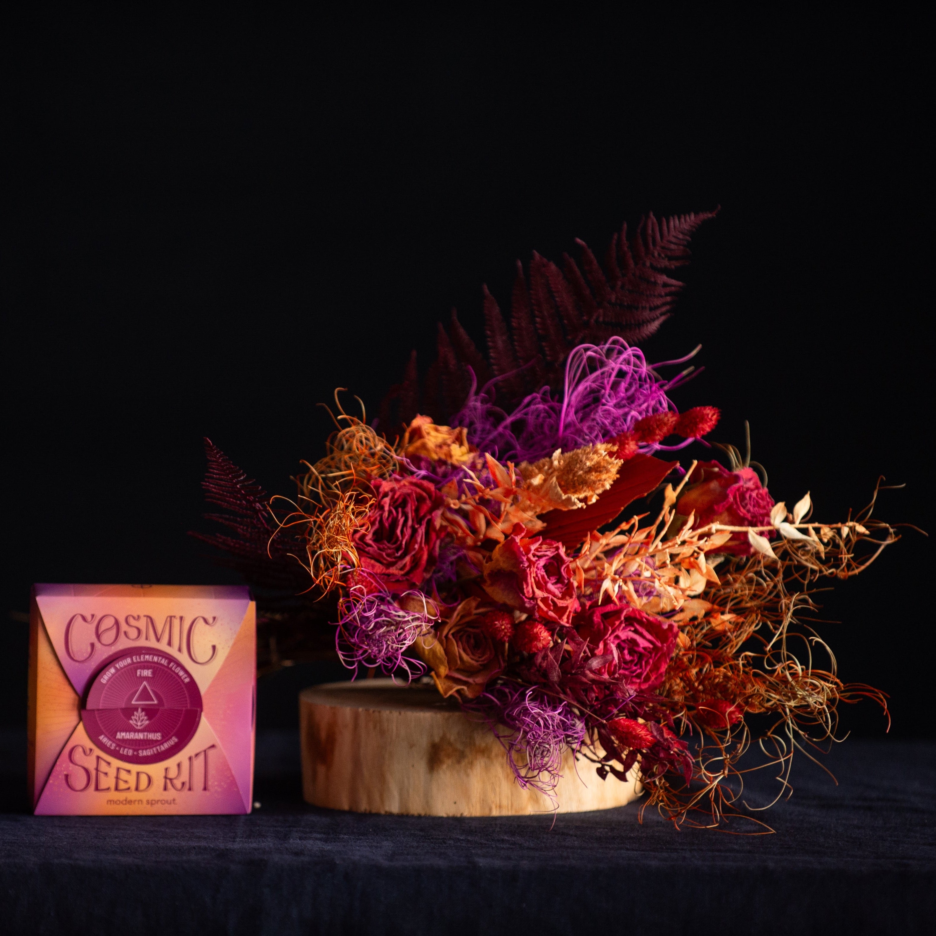 A bouquet of preserved & dried flowers in FIRE colors  with a coordinating cosmic seed kit. 
