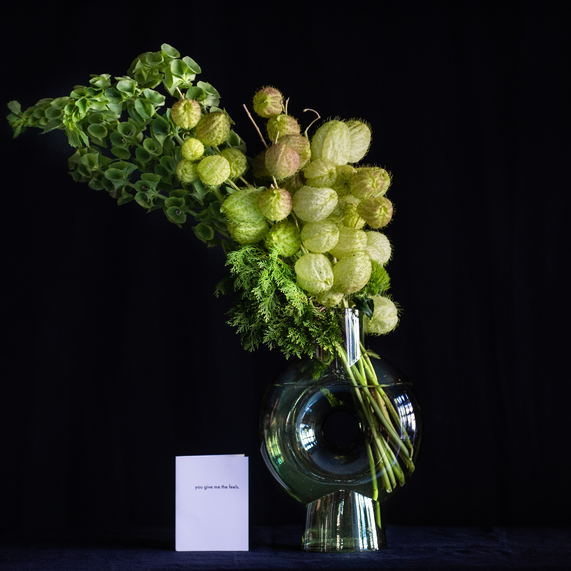 Grinch inspired green holiday design in a green glass vase  