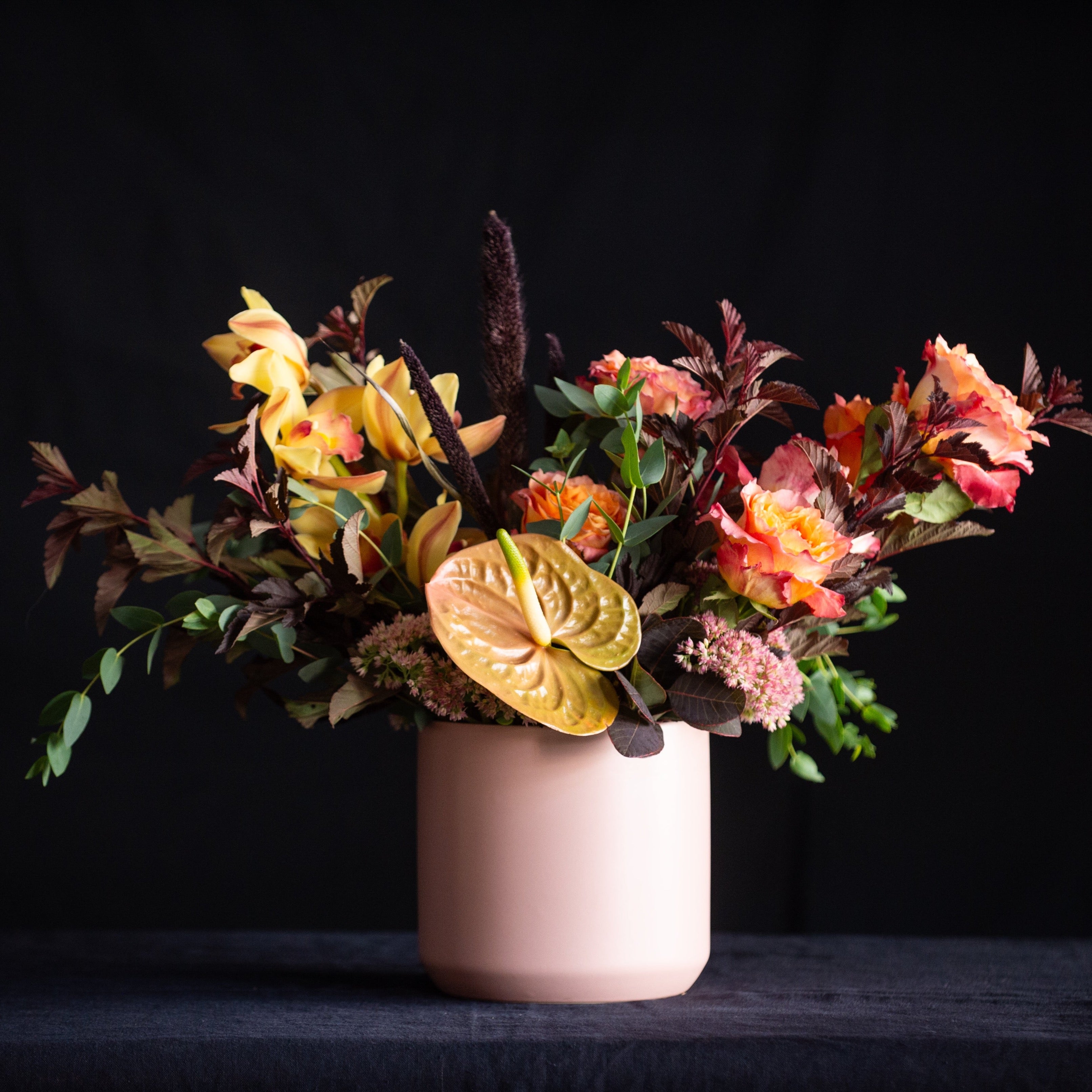 This harvest of a floral design has it all - roses, orchids, anthurium, fall leaves, in a color palette that is to die for! 