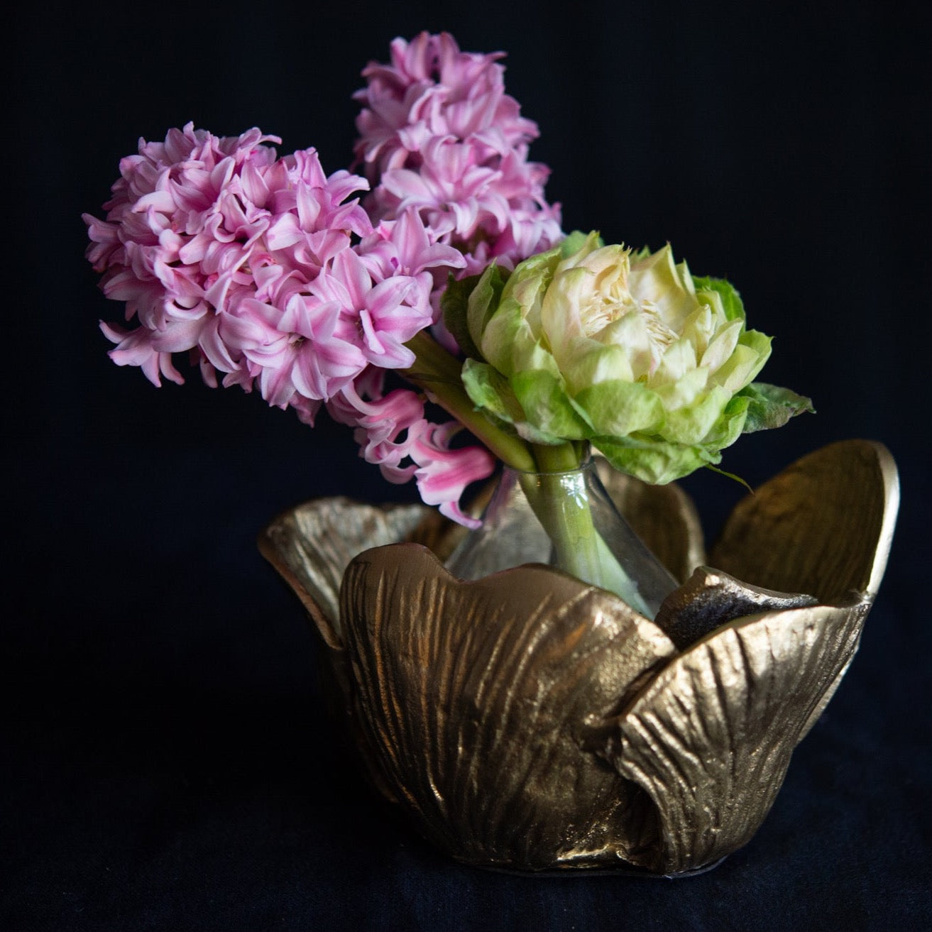 Blooming gold lotus bud vase filled with premium seasonal stems