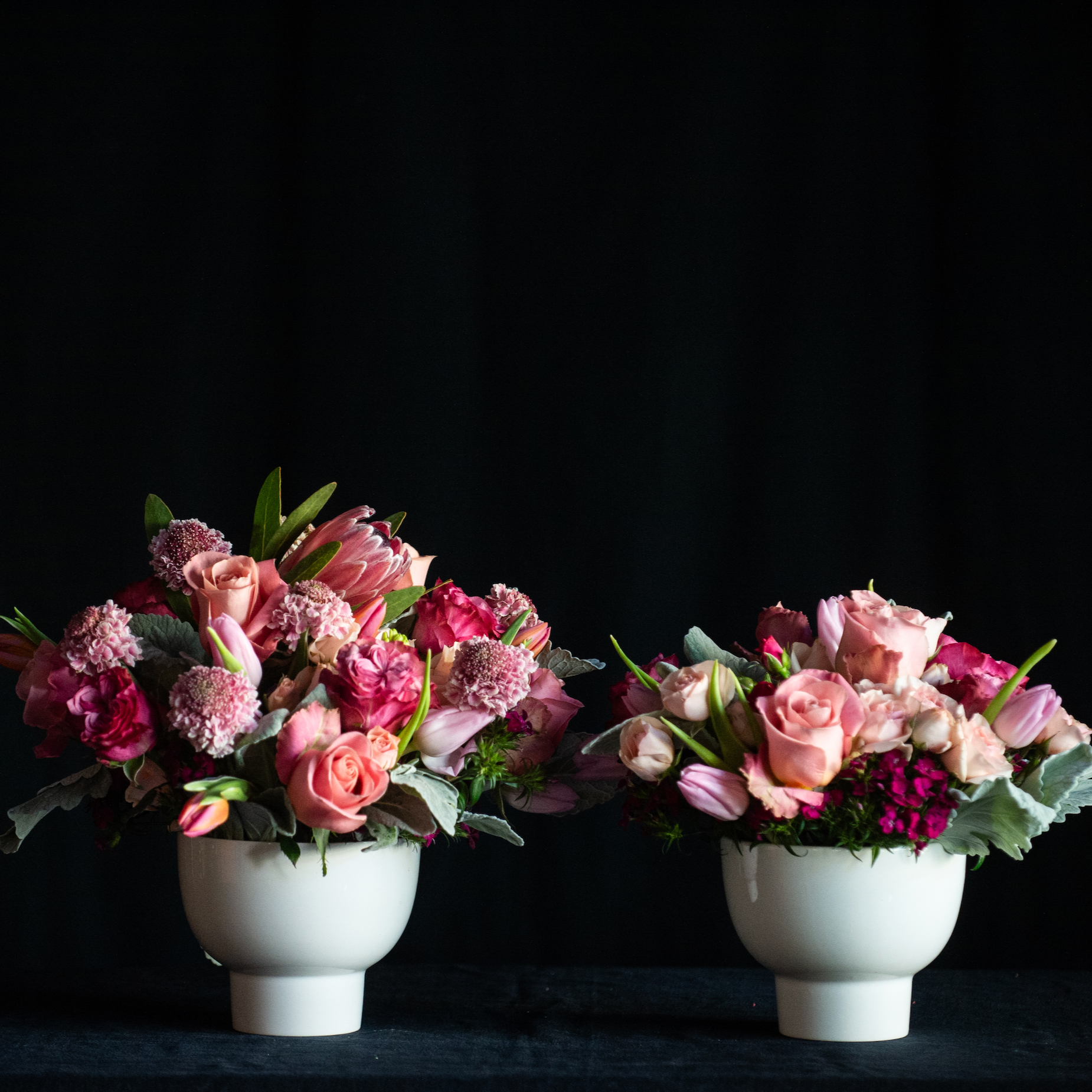 Pink Roses and accents for Valentines Day in a white ceramic container