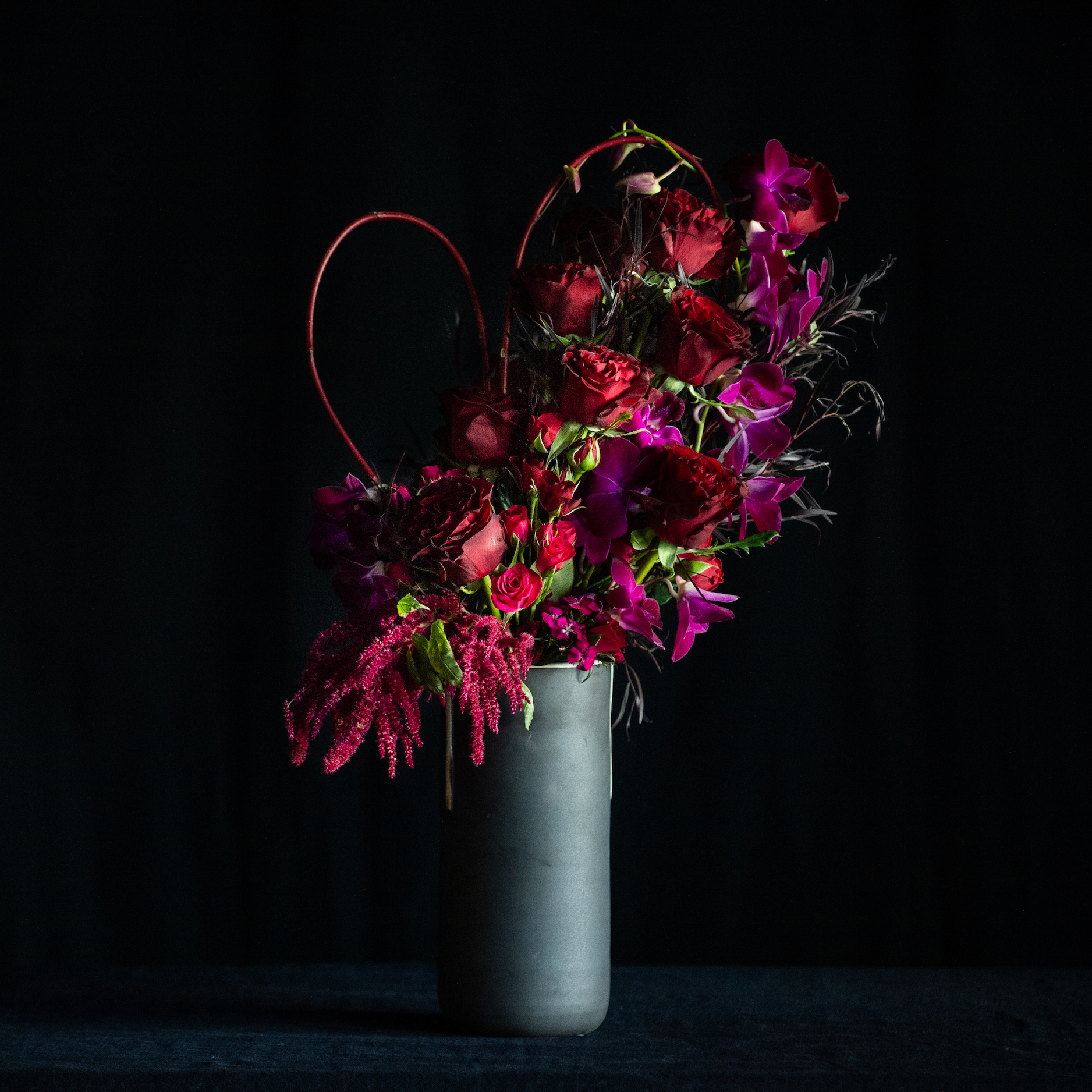 Dozen long stem red roses in a matte black container