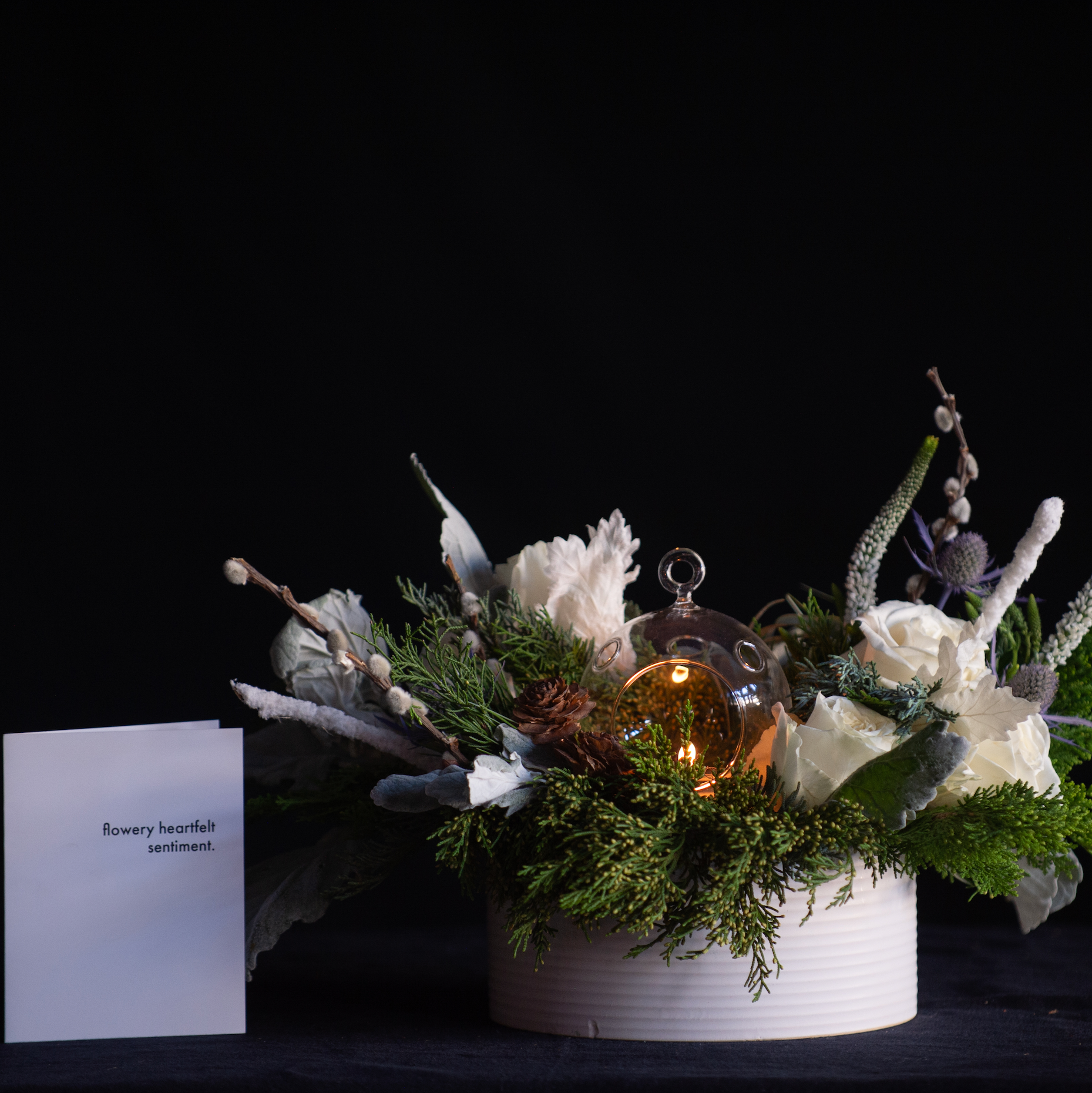 White winter holiday centerpiece with candlelight 