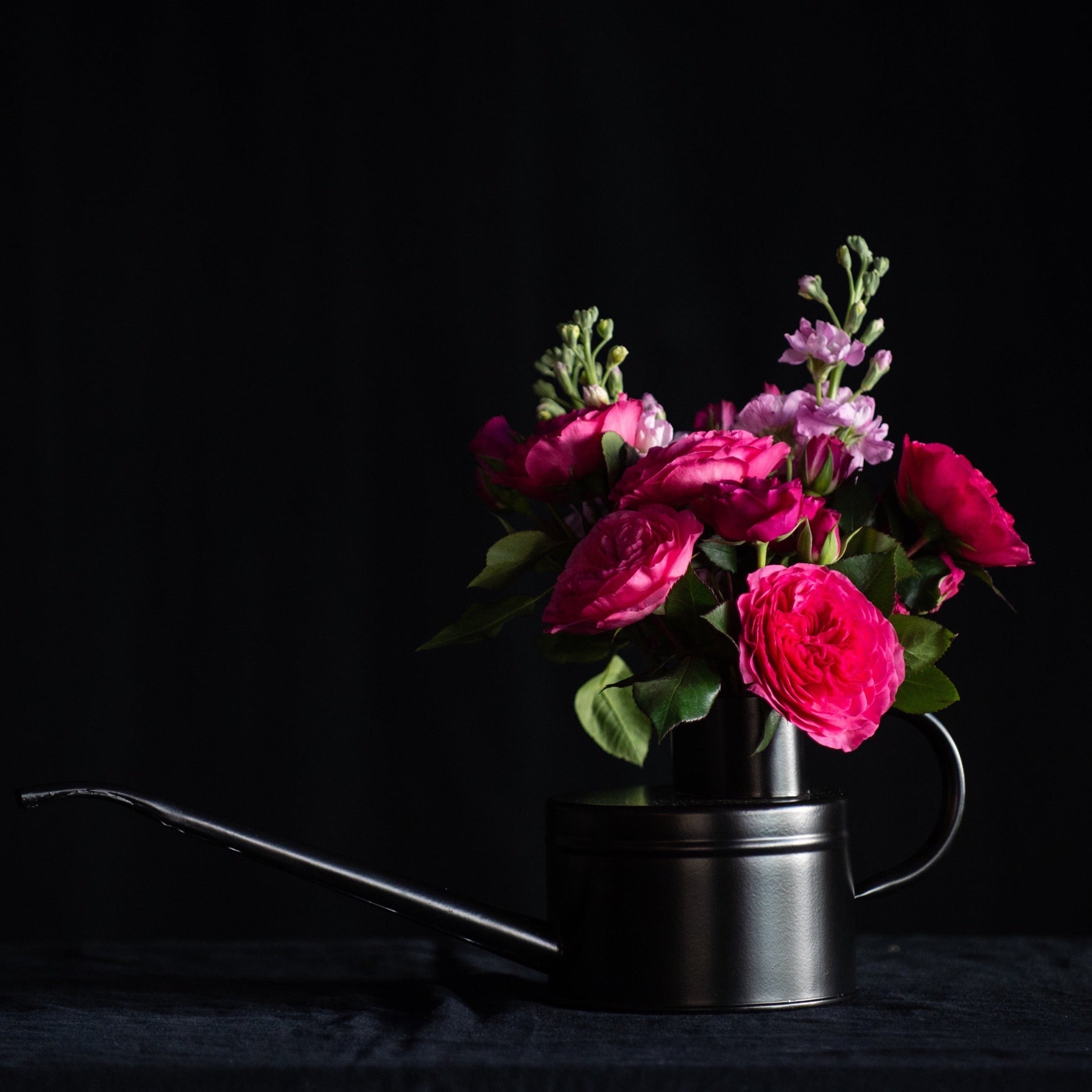 Valentines day flowers in a black watering can