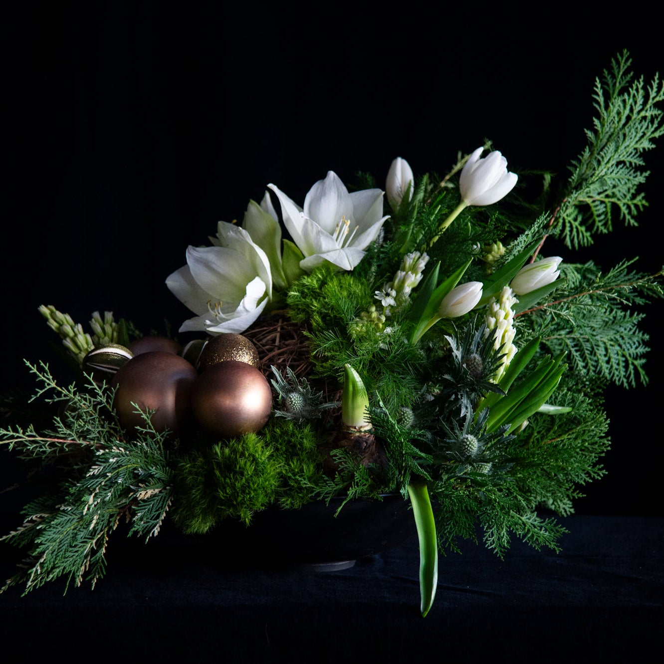oversized floral design of winter greens, and premium white stems