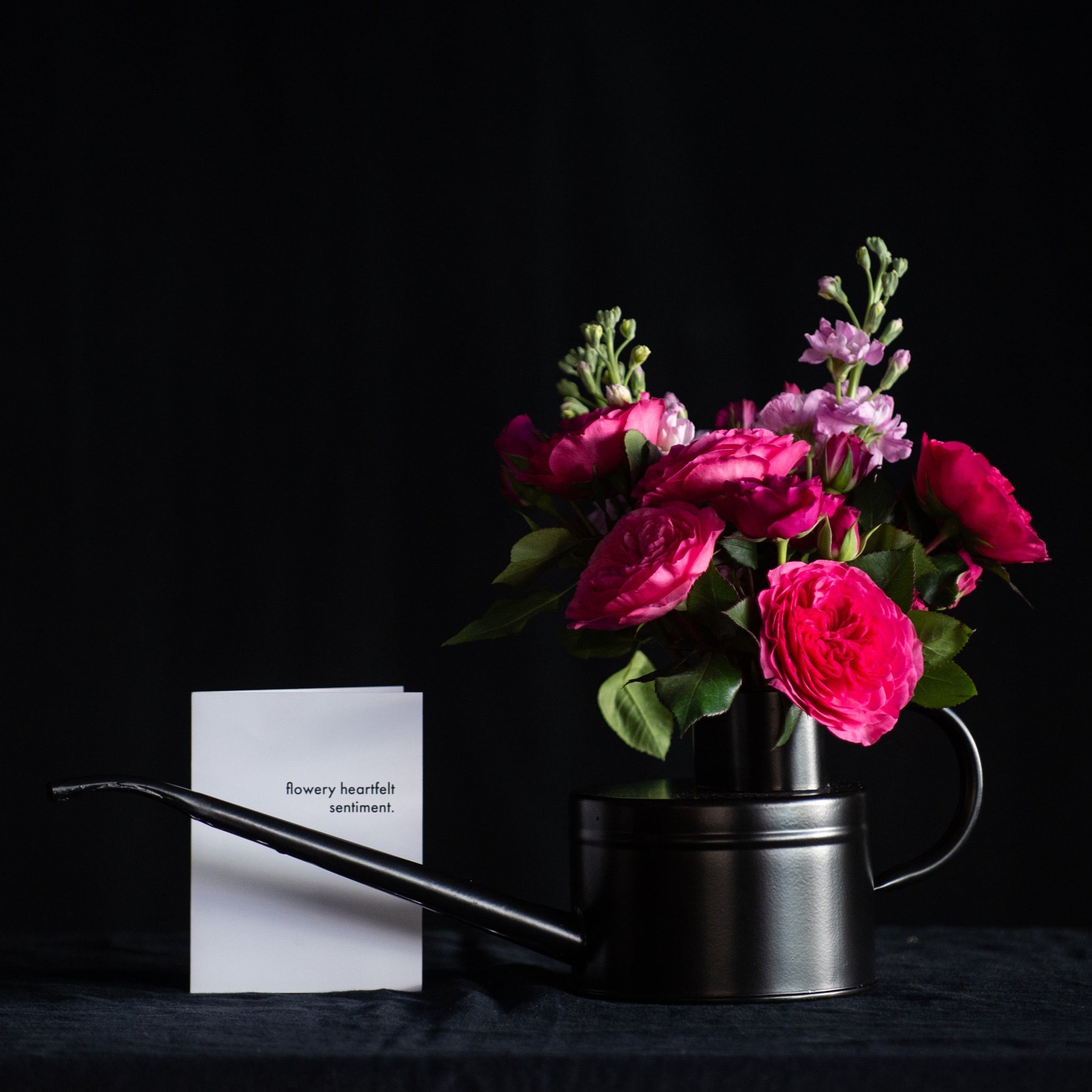 Valentines day flowers in a black watering can