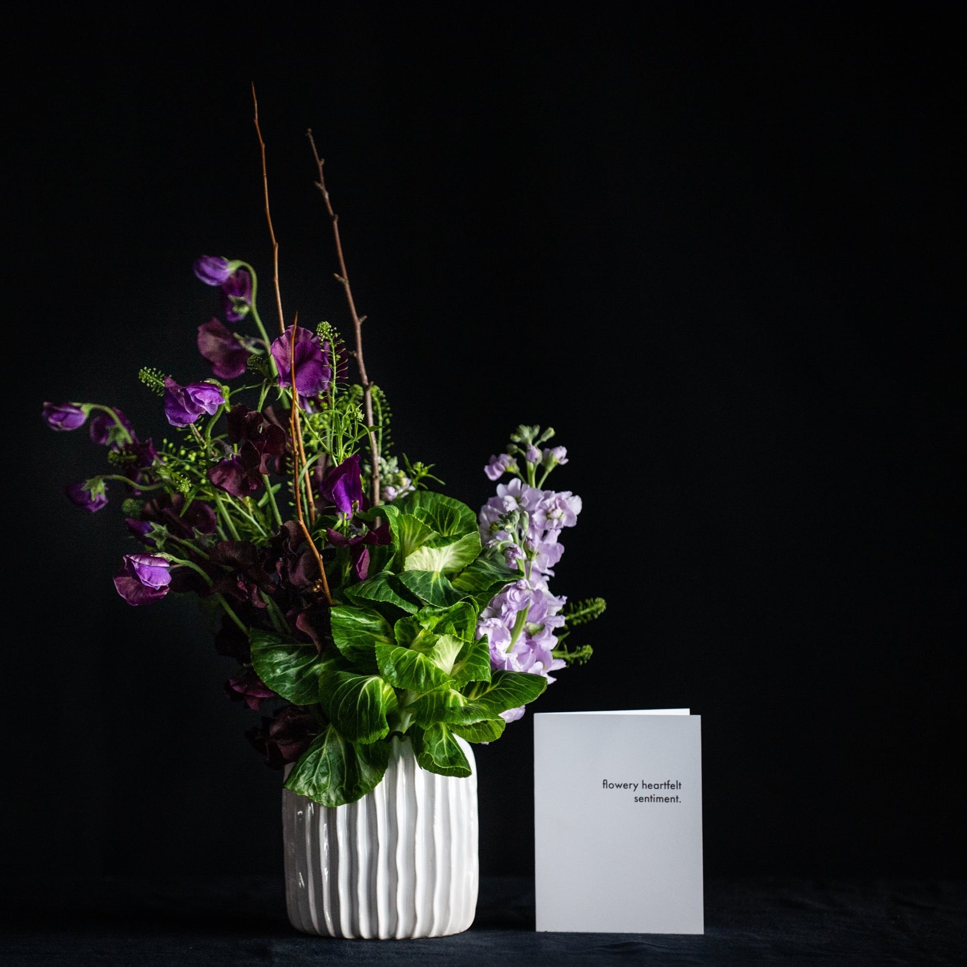 Blooming branches, sweet peas, stock, and KALE! This super fun, textural design is maybe a bit minimalist, but definitely interesting. 