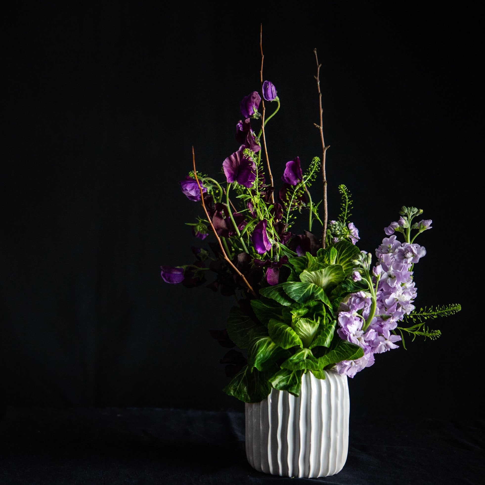 Blooming branches, sweet peas, stock, and KALE! This super fun, textural design is maybe a bit minimalist, but definitely interesting. 