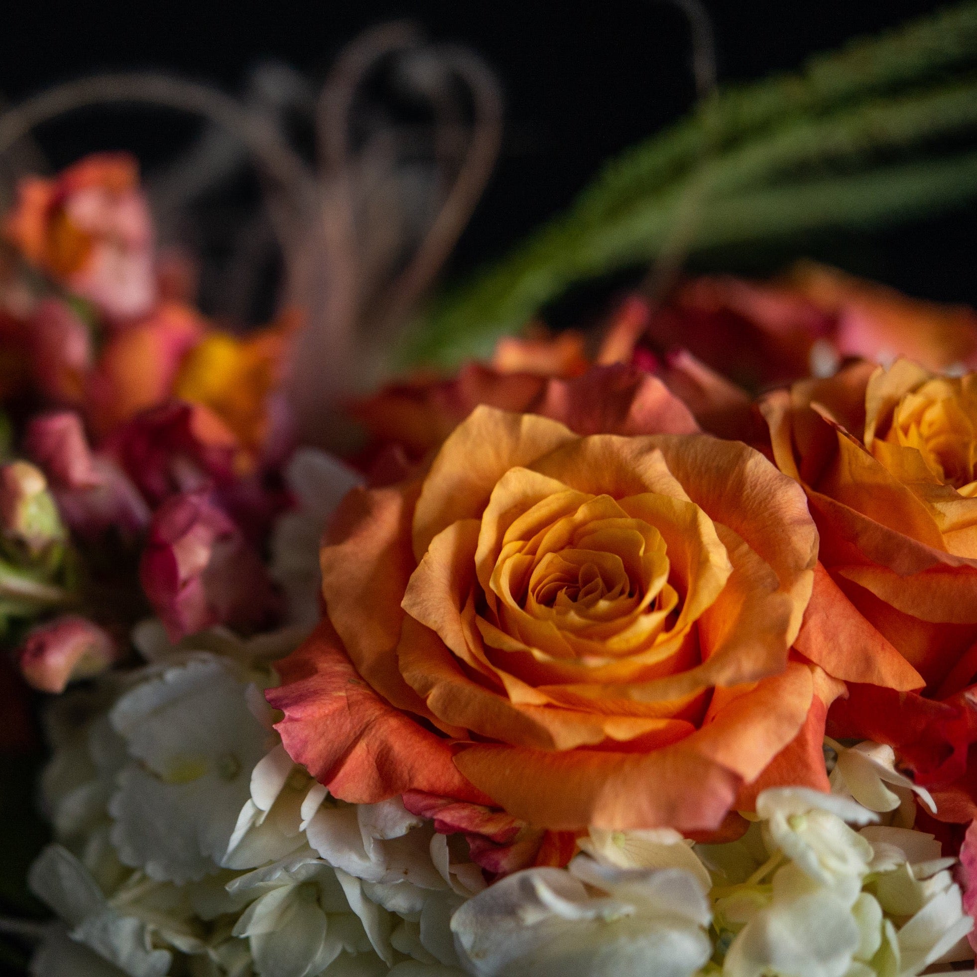 Filled with white hydrangea, orange roses, and salmon snapdragons it's all about peachy perfection 