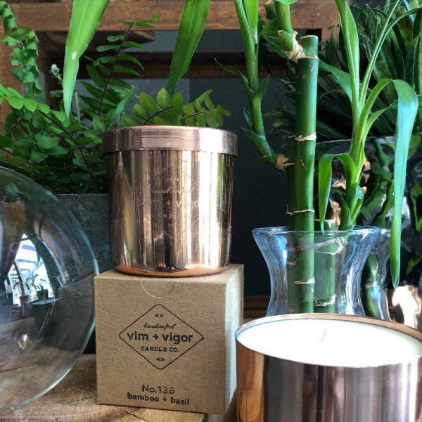 Bamboo & Basil scented candle by vim + vigor. The candle is in a reusable copper candle