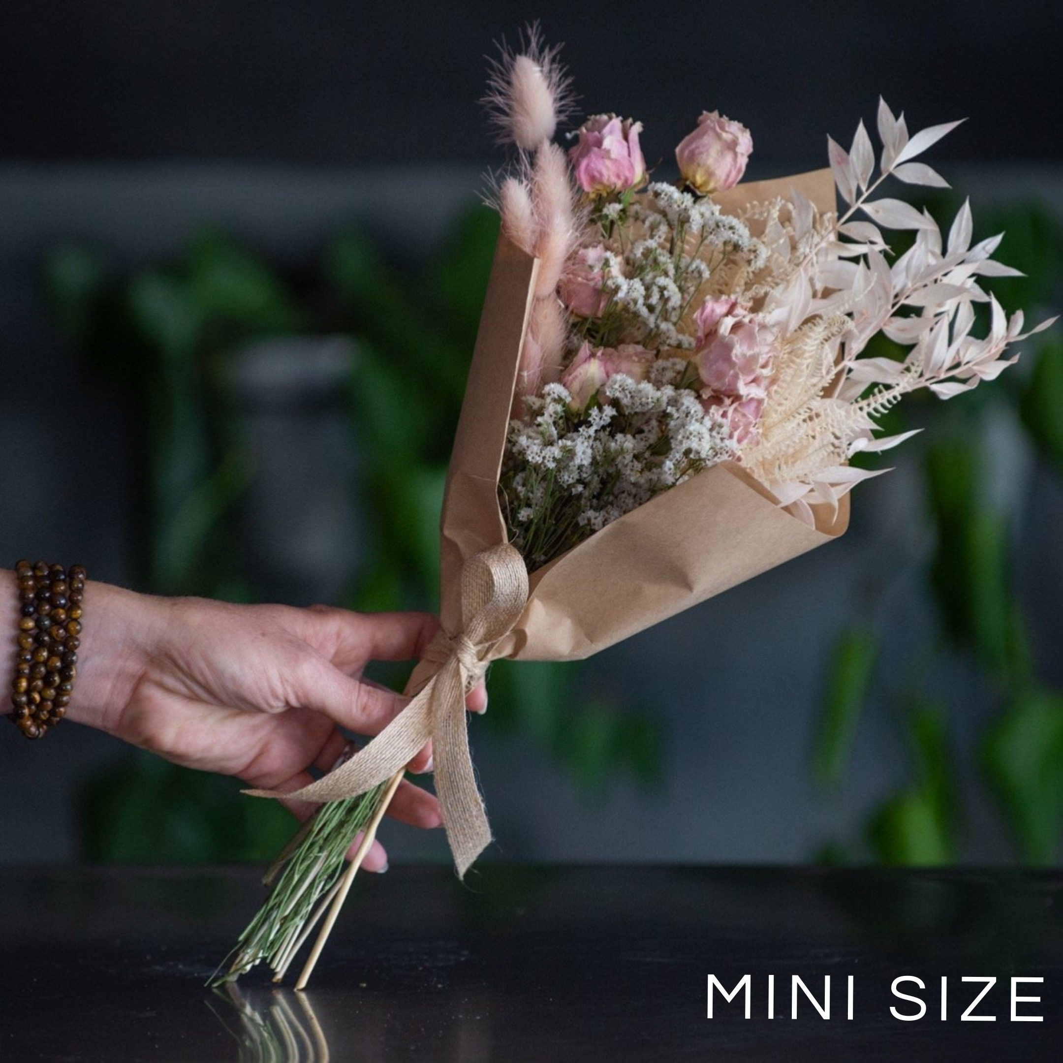  A small hand tied bouquet of dried and preserved flowers. Wrapped in a craft wrap.