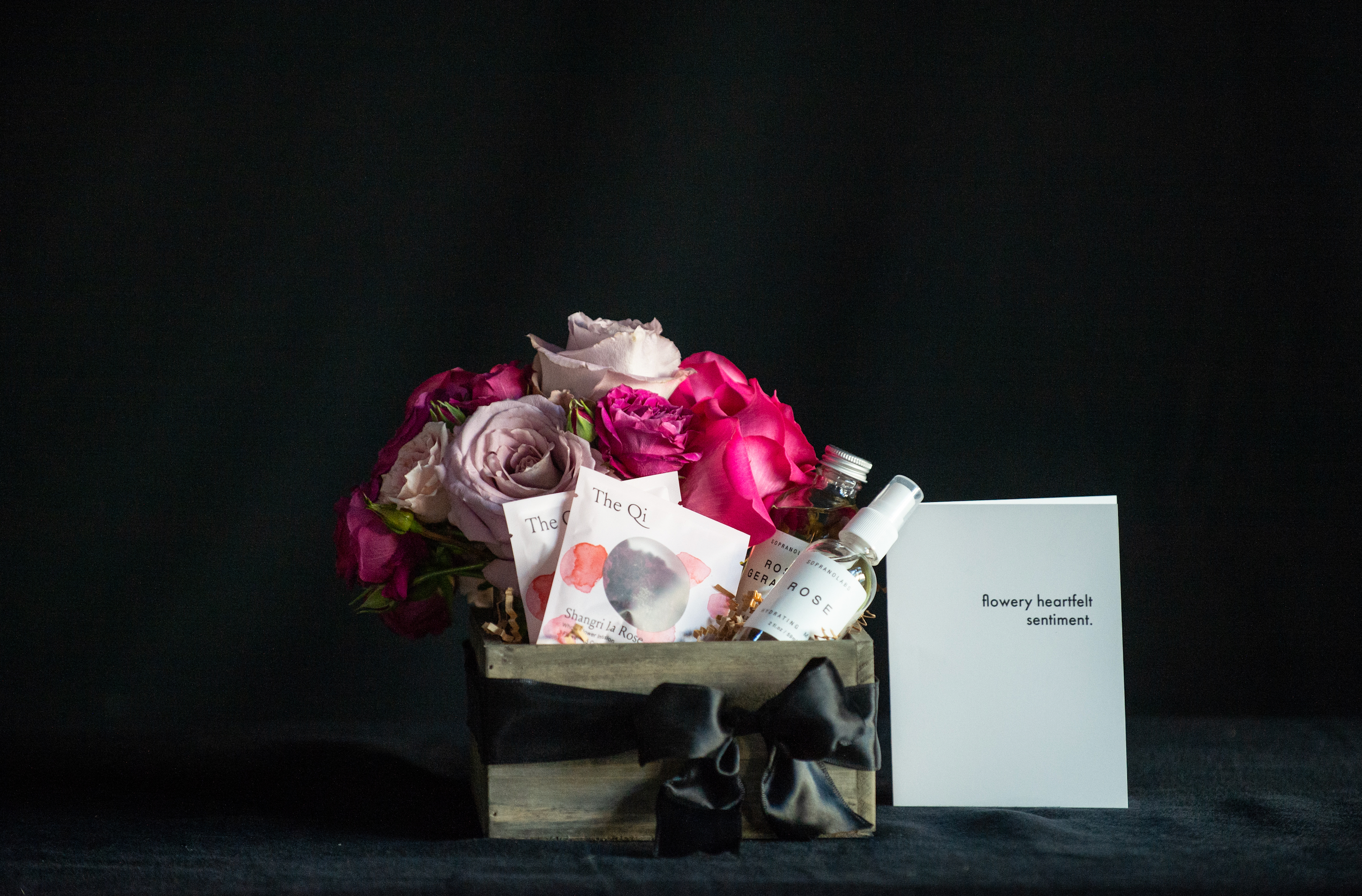 Gift box filled with all things roses - a rose bouquet, rose tea, rose facial steam, and rose mist. 