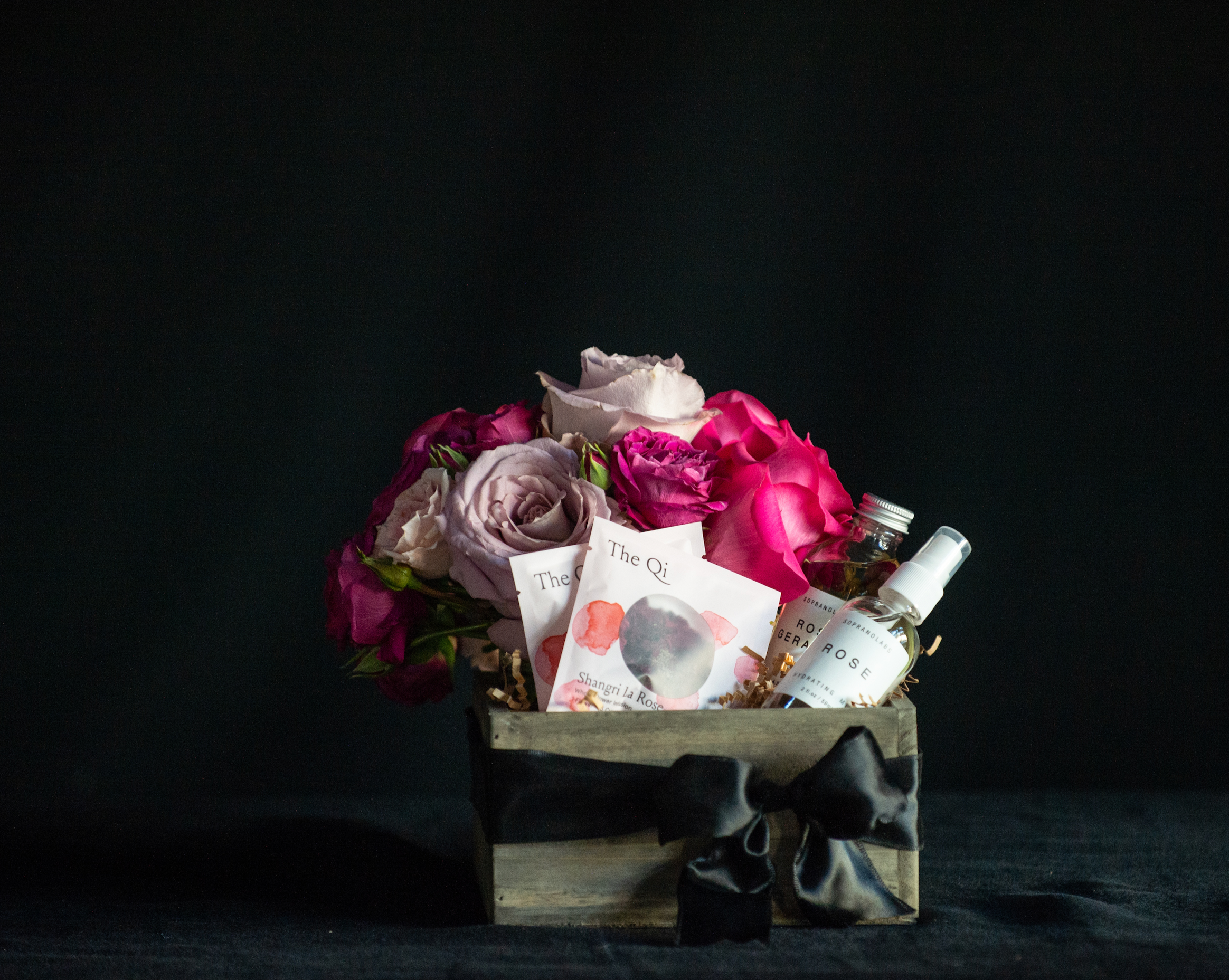 Gift box filled with all things roses - a rose bouquet, rose tea, rose facial steam, and rose mist. 