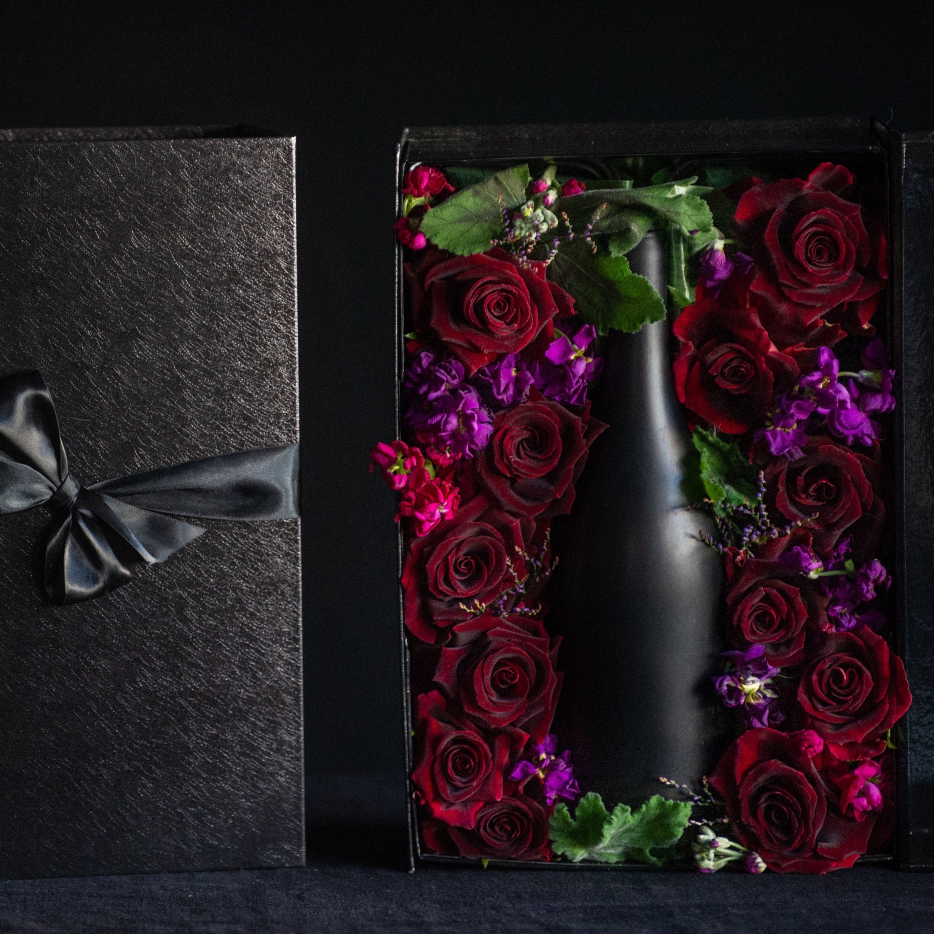 The perfect way to package your gift. A box tightly filled with a dozen roses to surround your favorite bottle.