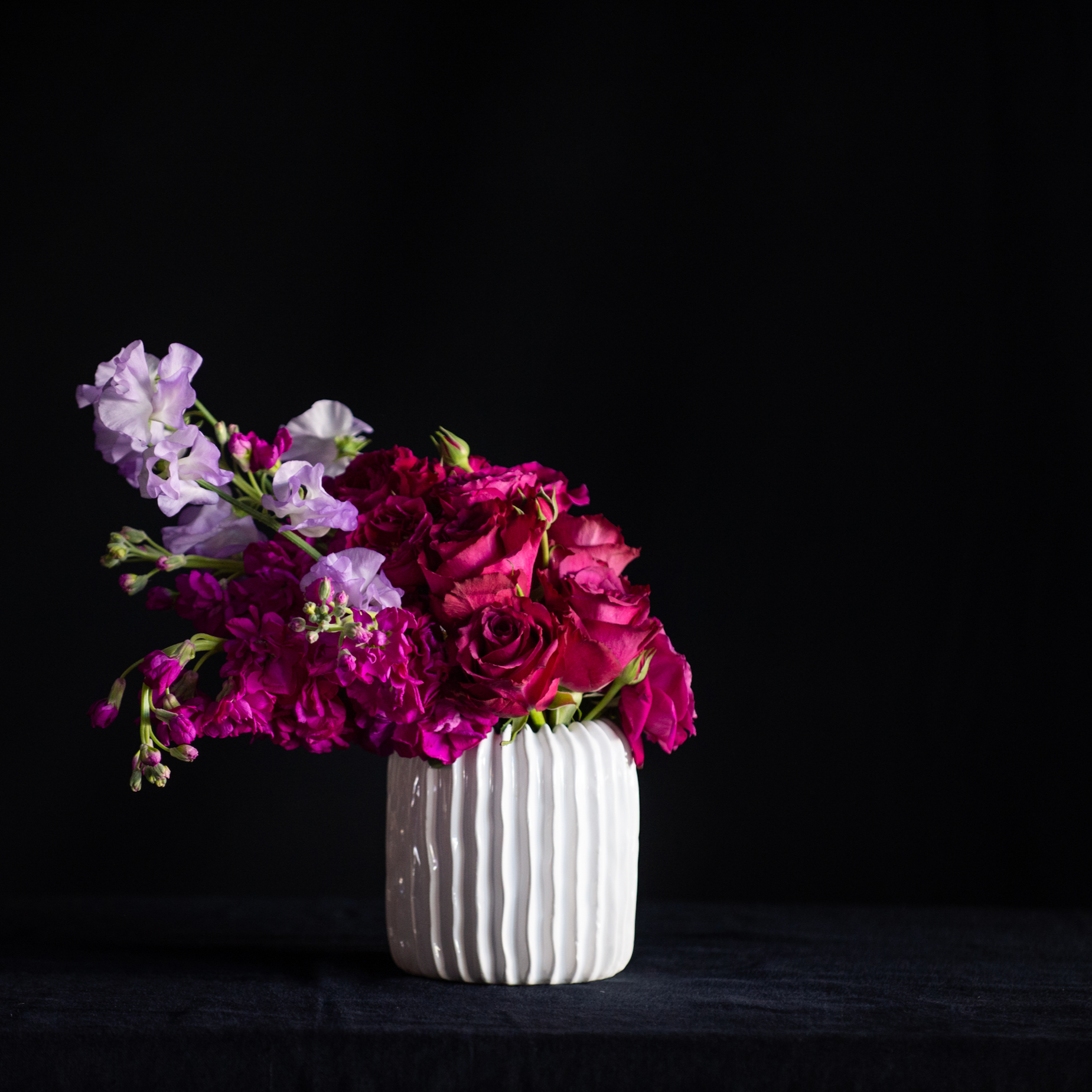 A fragrant Valentine's Day flower arrangement of roses, stock and sweet peas. 