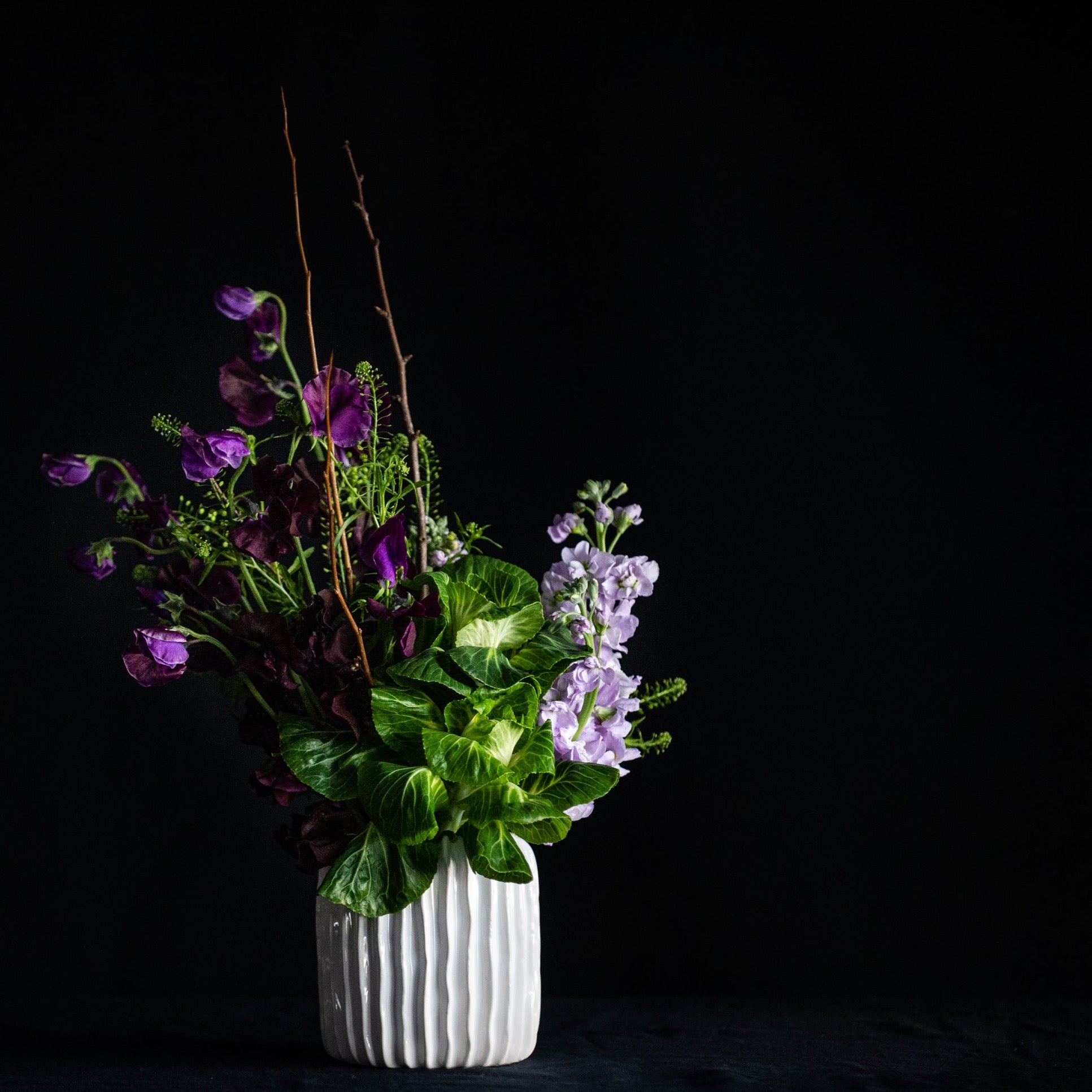 Blooming branches, sweet peas, stock, and KALE! This super fun, textural design is maybe a bit minimalist, but definitely interesting. 