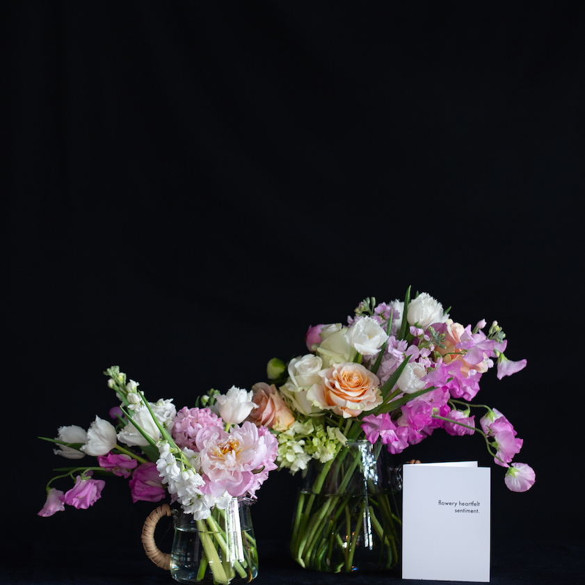 floral design in a clear glass pitcher pastel flowers